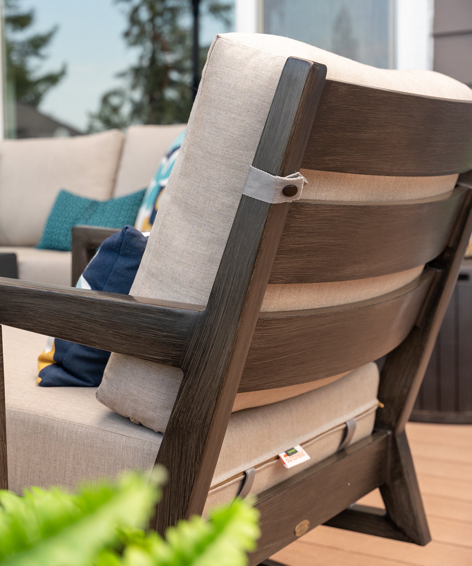 Close-up of the back of a metal outdoor chair with cushions