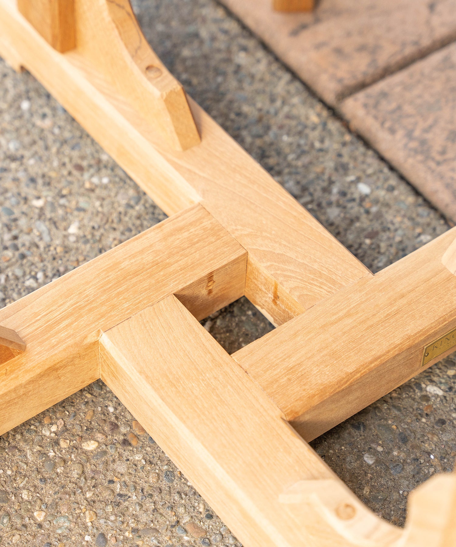 Close-up of the base of a teak outdoor table